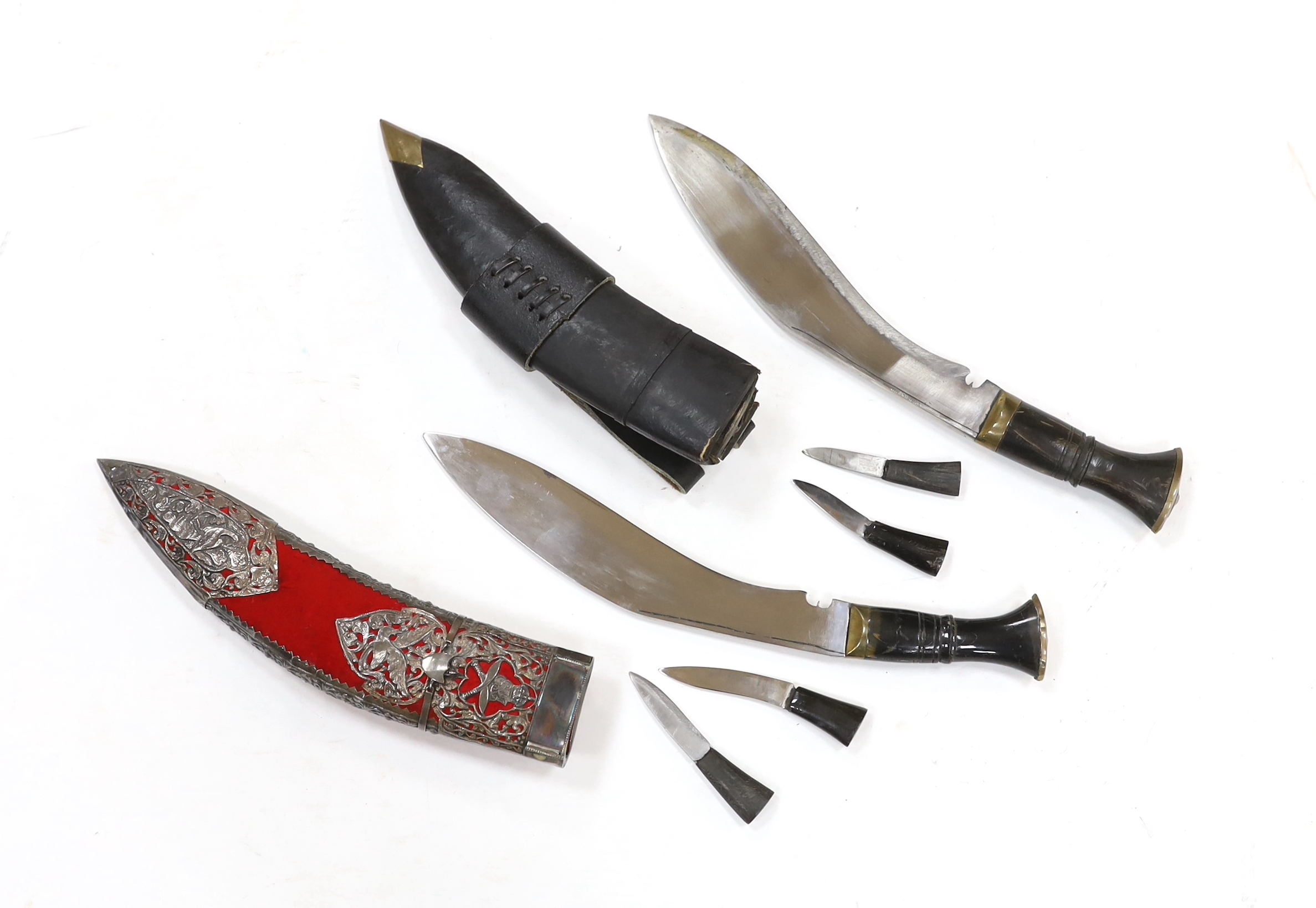 Two Kukri daggers in scabbards also containing two smaller daggers